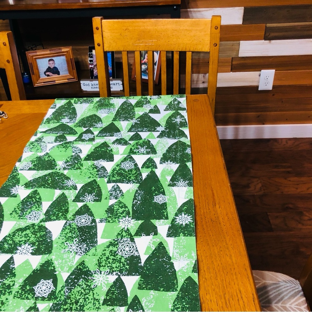 Crate & Barrel Snowy Forest, Shades of green on white Table Runner, 24”x90”.